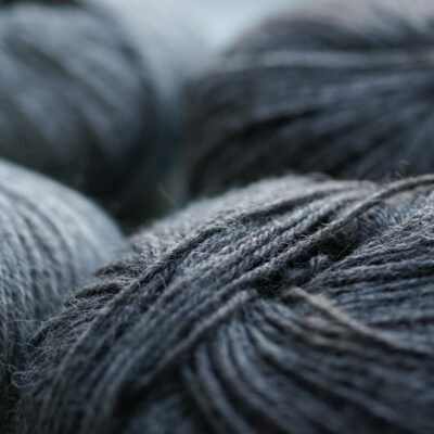 Skeins of gray woolen yarn on table